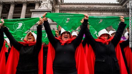 Activists in favor of the legalization of abortion disguised as characters from "The Handmaid's Tale" display green headscarves as they perform outside the National Congress in Buenos Aires, Argentina, on July 25, 2018.