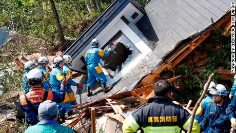 Police search for missing persons around a house destroyed by a landslide after a powerful earthquake in Atsuma town, Hokkaido, northern Japan.