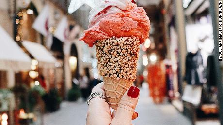 Woman's hand holding ice cream Florence street Italy