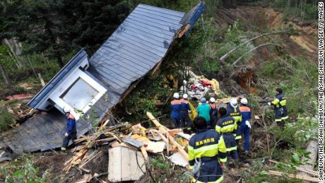 A rescue operation is conducted at a house destroyed by a landslide after a powerful earthquake on September 6, 2018 in Atsuma, Hokkaido, Japan. 