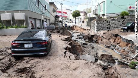 A car is seen stuck on a road damaged by an earthquake in Sapporo, Japan, on September 6, 2018.