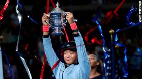 Naomi Osaka, of Japan, holds the trophy after defeating Serena Williams in the women&#39;s final of the U.S. Open tennis tournament, Saturday, September 8 in New York.