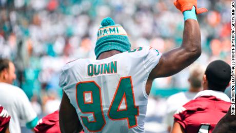 Quinn raises his fist during the national anthem against the Tennessee Titans.