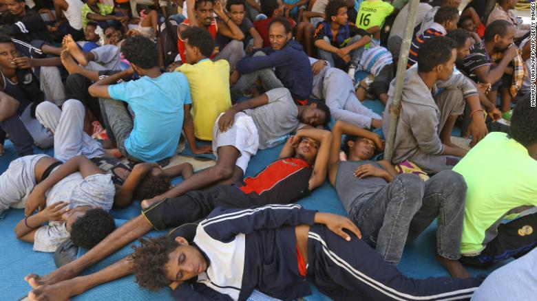 Illegal migrants sit inside the Ganzour shelter after being transferred from in the  airport road due to fighting in the Libyan capital Tripoli on September 5, 2018.