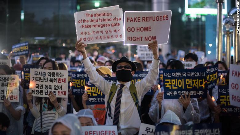 Anti-immigration activists attend a protest against a group of asylum-seekers from Yemen, in Seoul on June 30, 2018.