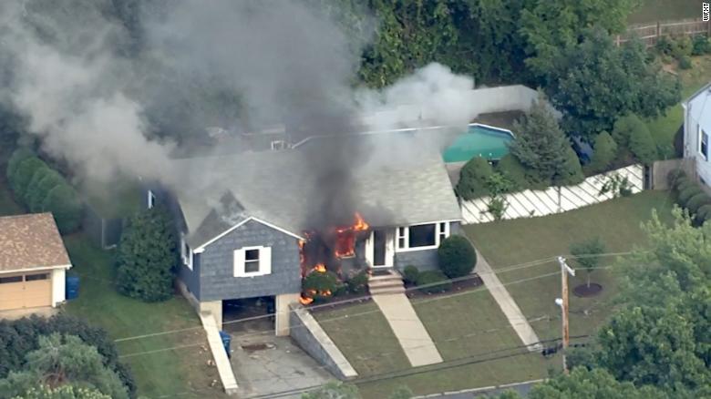 A house goes up in flames Thursday in northeastern Massachusetts north of Boston.