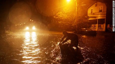 Michael Nelson floats in a boat made from a metal tub and fishing floats after the Neuse River went over its banks and flooded his street during Hurricane Florence September 13, 2018 in New Bern, North Carolina. Some parts of New Bern could be flooded with a possible 9-foot storm surge as the Category 2 hurricane approaches the United States. 