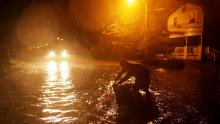 Michael Nelson floats in a boat made from a metal tub and fishing floats after the Neuse River went over its banks and flooded his street during Hurricane Florence September 13, 2018 in New Bern, North Carolina. Some parts of New Bern could be flooded with a possible 9-foot storm surge as the Category 2 hurricane approaches the United States. 