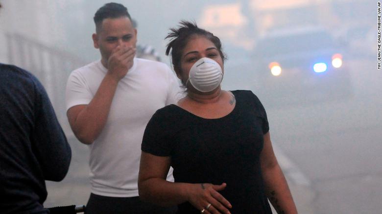 Residents protect their faces against the smoke while being evacuated Thursday in Lawrence, Massachusetts.