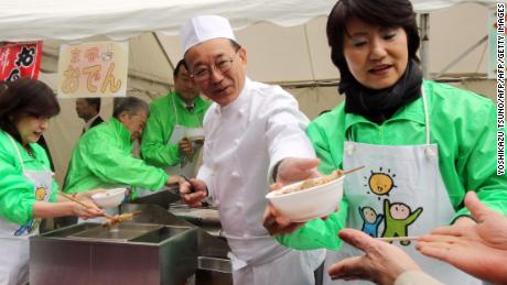 Sadakazu Tanigaki, then-secretary general of Japan&#39;s ruling Liberal Democratic Party (LDP) serves bowls of whale meat curry and oden -- a Japanese hot pot dish -- to party members at the LDP headquarters in Tokyo in 2015. 