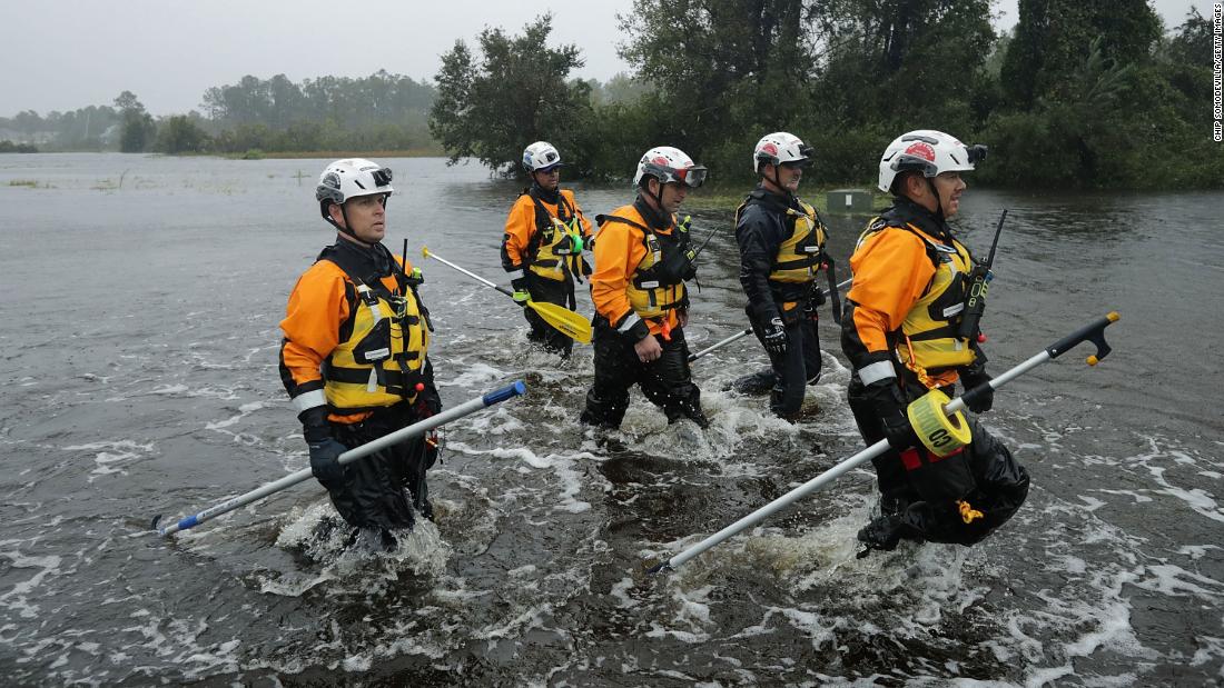 Members of a Federal Emergency Management Agency team from California search a flooded neighborhood in Fairfield Harbour, North Carolina, on September 14.