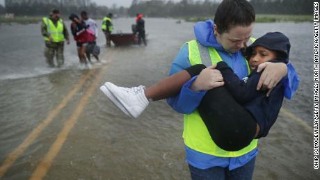 Volunteers from the Civilian Crisis Response Team rescue three children in James City, North Carolina.