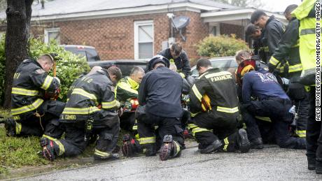 Firefighters kneel, pray after mother and baby die from falling tree