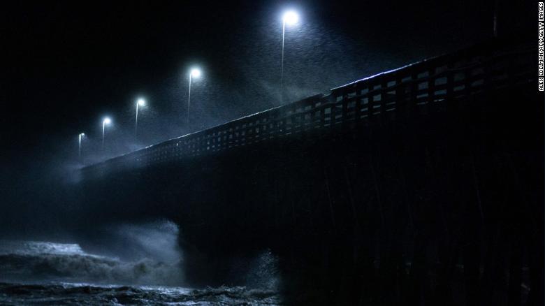 Waves crash into the Second Avenue Pier in Myrtle Beach, South Carolina, on Friday, September 14.