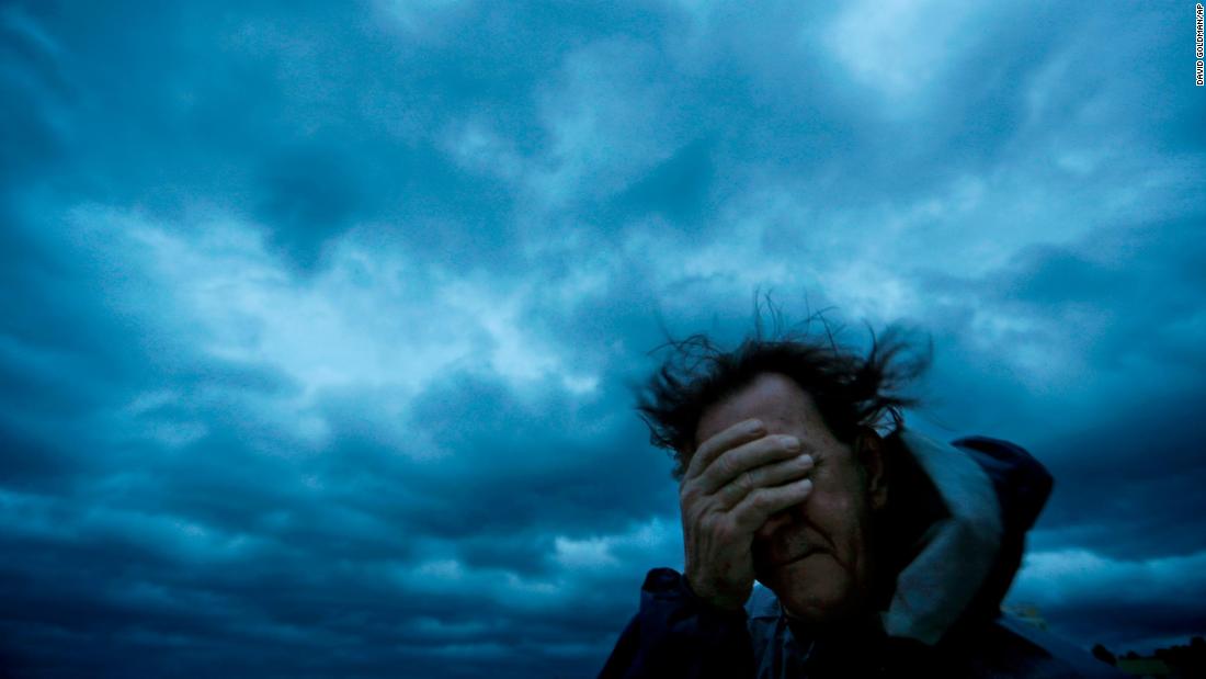 Russ Lewis covers his eyes from wind and sand in Myrtle Beach, South Carolina, on September 14.