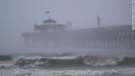 Intense waves crash onto a pier Friday in North Myrtle Beach, South Carolina. 