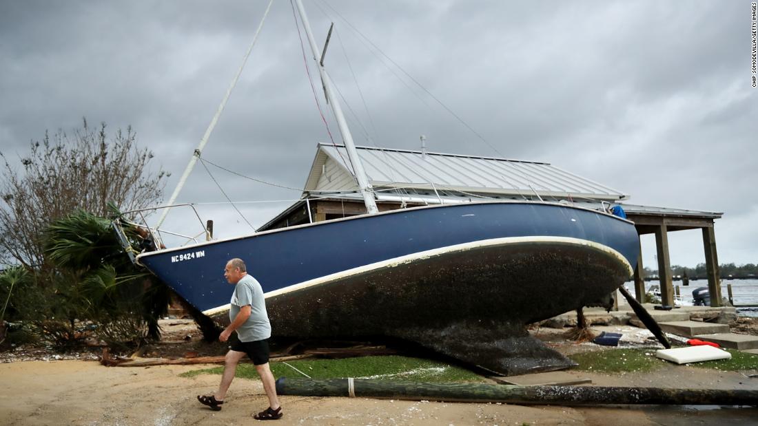 A sailboat lifted by storm surge leans against a building at Bridgepointe Marina in New Bern, North Carolina, on Saturday, a day after Florence&#39;s landfall.