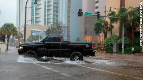 A car drives though rising floodwaters near the beach as Hurricane Florence makes landfall on Friday in Myrtle Beach, South Carolina.