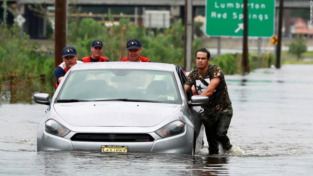 Members of the Coast Guard help a stranded motorist in floodwaters in Lumberton, North Carolina, on September 16.
