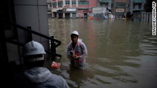 Rescuers evacuate local residents from flooded areas in heavy rains caused by Typhoon Mangkhut in Macau.