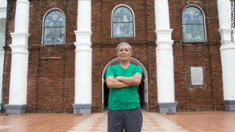 Arthur Pagador, 68, stands in front of Buguey's church. 