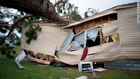 A large tree that fell during Hurricane Florence lies on top of a home in the Evergreen mobile home park in Newport, North Carolina. 