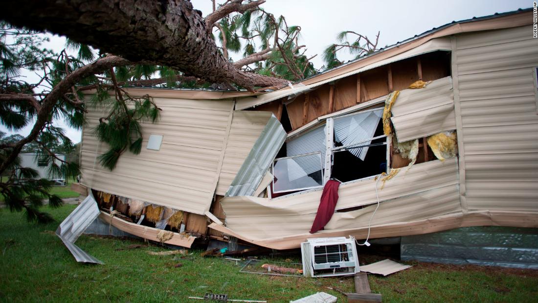 A large tree lies on top of a mobile home in Newport, North Carolina, on September 16.