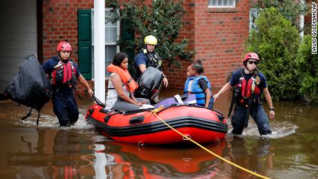 Rescue personnel evacuate residents as flooding in the aftermath of Hurricane Florence in Spring Lake, North Carolina.