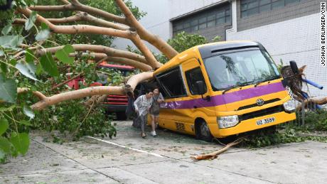 A school bus in Hong Kong&#39;s Heng Fa Chuen is seen after being destroyed by a tree during Typhoon Mangkhut.