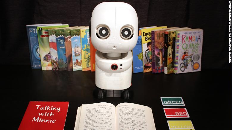 Minnie, a learning companion robot, listens and makes occasional comments while children read.