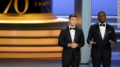 Colin Jost  and Michael Che speak onstage during the 70th Emmy Awards