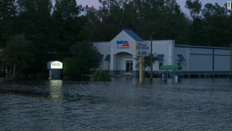 Duplicates INK, a printing company in Conway, South Carolina, is in danger of flooding. The business' owner, John Cassidy, and the employees are at work anyway. 