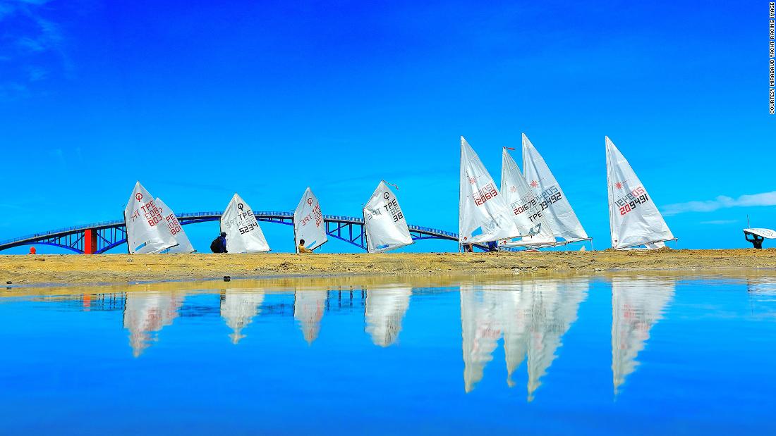 During the Taiwan Regatta on Penghu Island, Lien Shou Lin photographed sails and their reflections, as the boats gathered at the starting line.