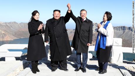 North Korean leader Kim Jong Un and his wife Ri Sol Ju pose with South Korean President Moon Jae-in and his wife Kim Jung-sook on the top of Mount Paektu in North Korea on September 20.