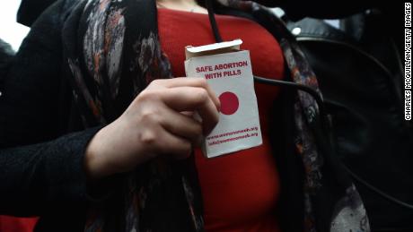 A  woman displays an abortion pill packet during a pro-choice protest in Belfast in May. 