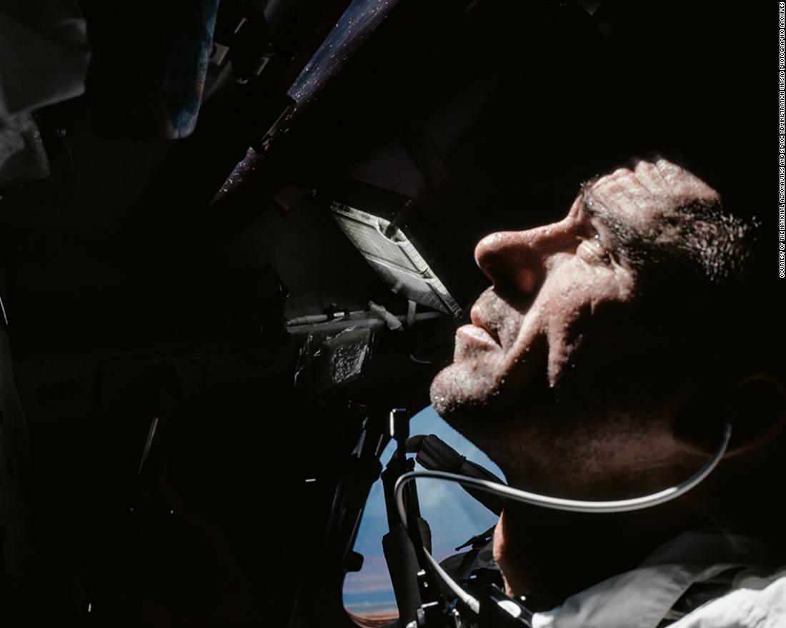 Astronaut Walt Cunningham looks out of the Command Module window during Apollo 7&#39;s 11-day orbit around the Earth. 