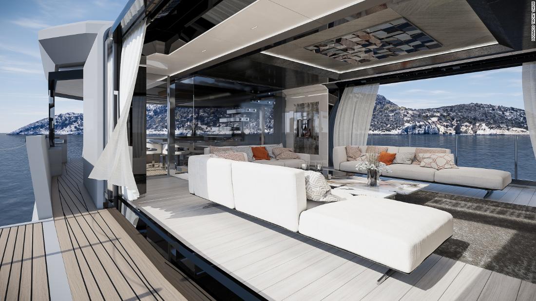It features a convertible skylounge and minimalistic interior decor with sliding glass doors and fold-out balconies. 
