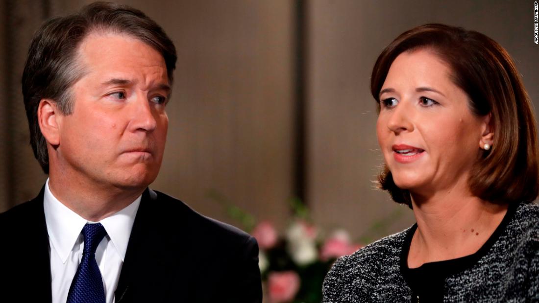 Brett Kavanaugh, left, looks at his wife Ashley Estes Kavanaugh as they answer questions during a Fox News interview.