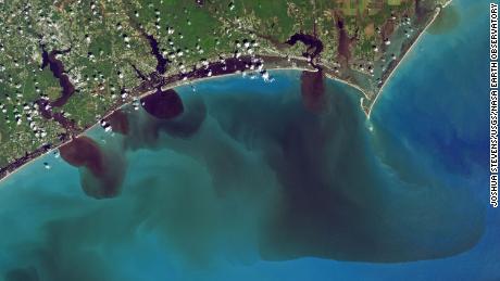 NASA image shows how soils, sediments, pollution and other debris have discolored the White Oak River, New River and Adams Creek, and their outflows along the coast and into the ocean.