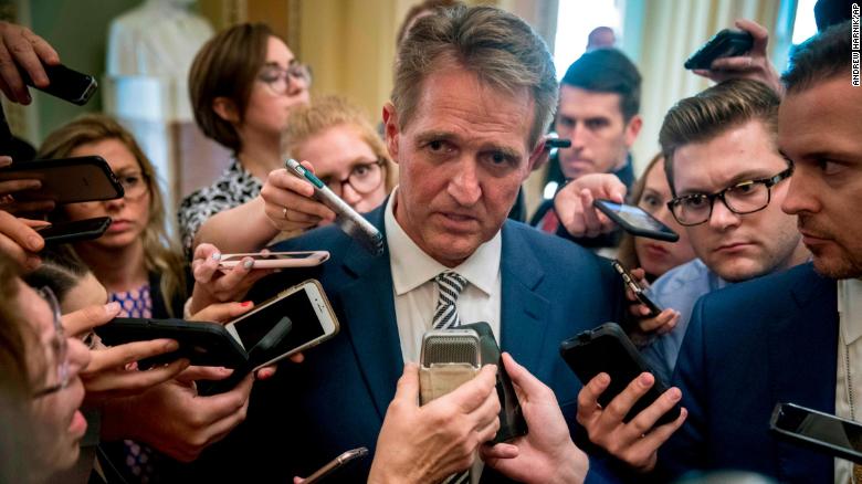Sen. Jeff Flake, R-Ariz., center, speaks with reporters after meeting with Senate Majority Leader Mitch McConnell of Ky., in his office in the Capitol in Washington, Friday, Sept. 28, 2018. The Senate Judiciary Committee advanced Brett Kavanaugh's nomination for the Supreme Court after agreeing to a late call from Sen. Jeff Flake, R-Ariz., for a one week investigation into sexual assault allegations against the high court nominee. (AP Photo/Andrew Harnik)