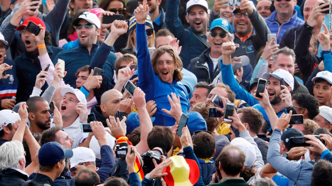 Team Europe&#39;s Tommy Fleetwood celebrates with spectators after winning the Ryder Cup on Sunday.