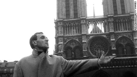 Charles Aznavour in front of Notre Dame de Paris. 