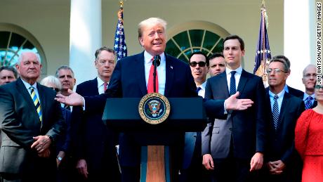 US President Donald Trump surrounded by staff speaks from the Rose Garden of the White House in Washington, DC, remarking on the United StatesMexicoCanada Agreement on October 1, 2018. (Photo by Jim WATSON / AFP)        (Photo credit should read JIM WATSON/AFP/Getty Images)