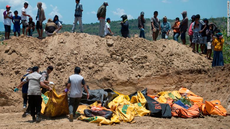 Body bags lie in an open ditch in Palu, Indonesia.