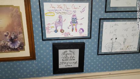 Kathy Felt&#39;s wall is covered with drawings and notes from volunteers&#39; children.