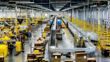 Inside an Amazon fulfillment center, a conveyer belt is used to organize packages.