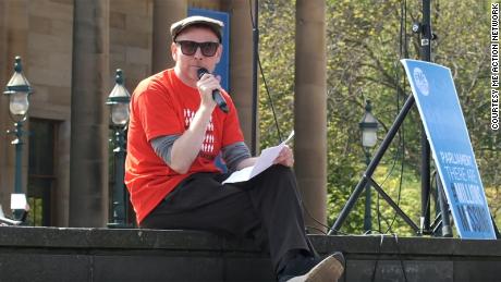 Murdoch addresses a crowd in Edinburgh, Scotland, at a #MillionsMissing rally.