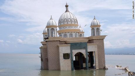 A mosque lies abandoned off the Palu coastline on Thursday. Even before the tsunami, locals called it the 'floating mosque' because it was on a jetty off the beach.