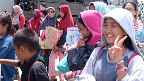 Hopeful passengers wait on the dock at Palu on Thursday, enthusiastic to board an Indonesian naval vessel which will take them away.