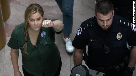 Comedian Amy Schumer is led away after she was arrested.